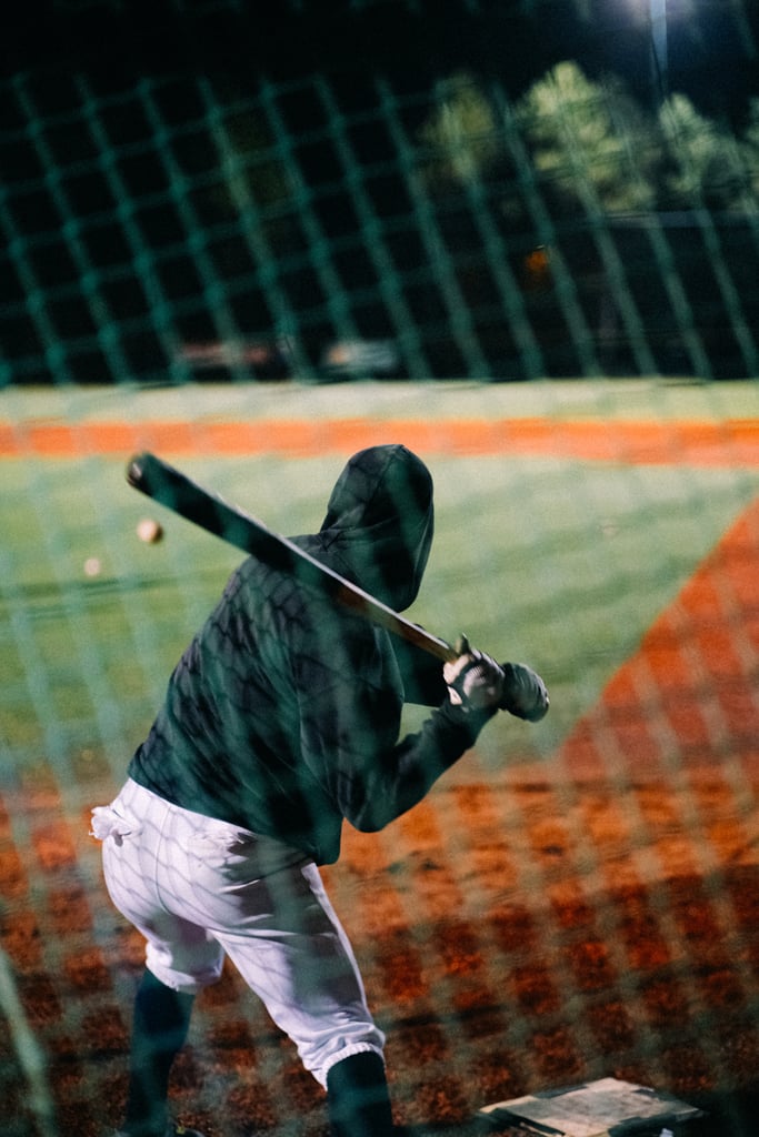 man at bat on baseball diamond getting ready to swing at ball showing medium intensity calorie burn sport

