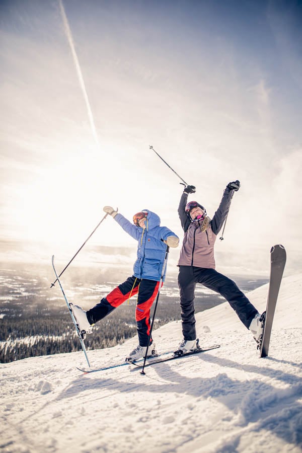 two female skiiers in a goofy pose