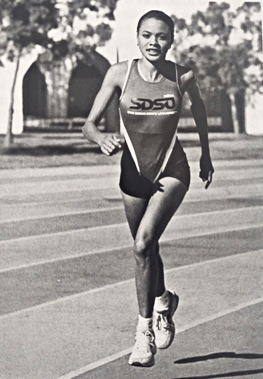 Kristy Matthews running track for San Diego State University in a black and white photo, circa 1995
