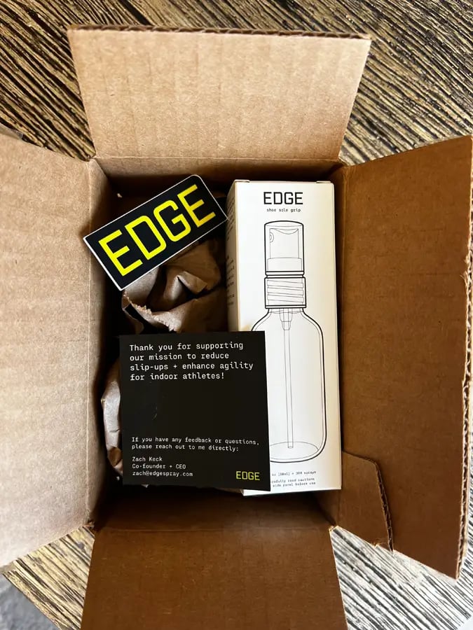 shipping package of EDGE shoe grip spray that includes the spray, an EDGE sticker, and a thank you card