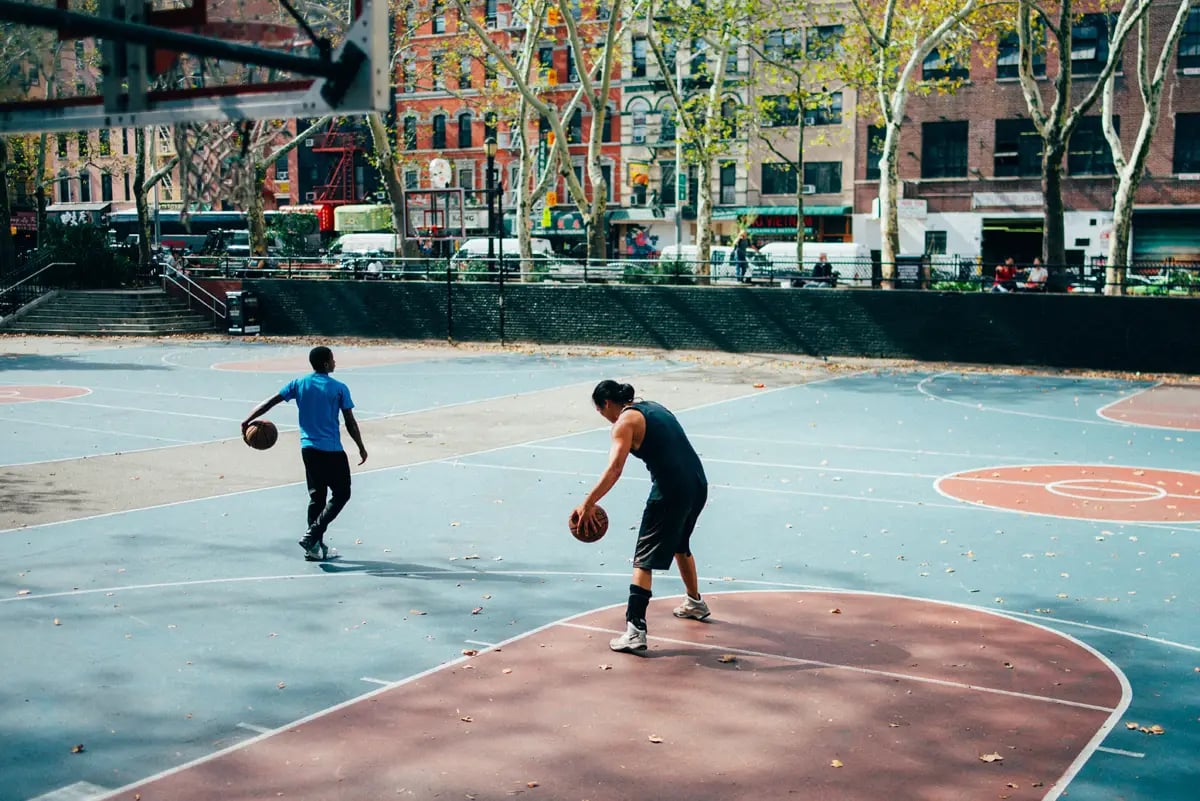 two men on basketball court in nyc
