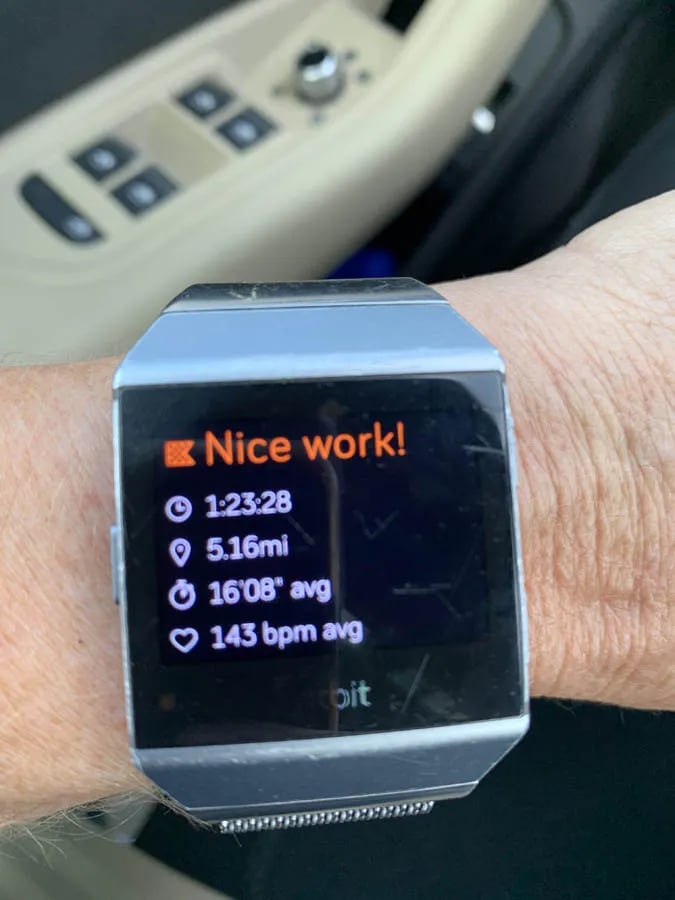 closeup of fitbit on woman's wrist showing workout stats and calorie burn

