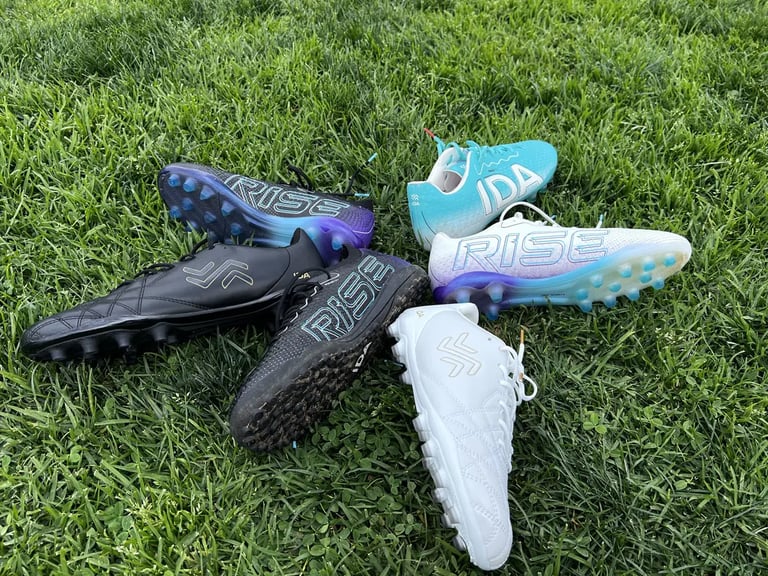 2024 line of IDA sports women's soccer cleats in a circle on grass