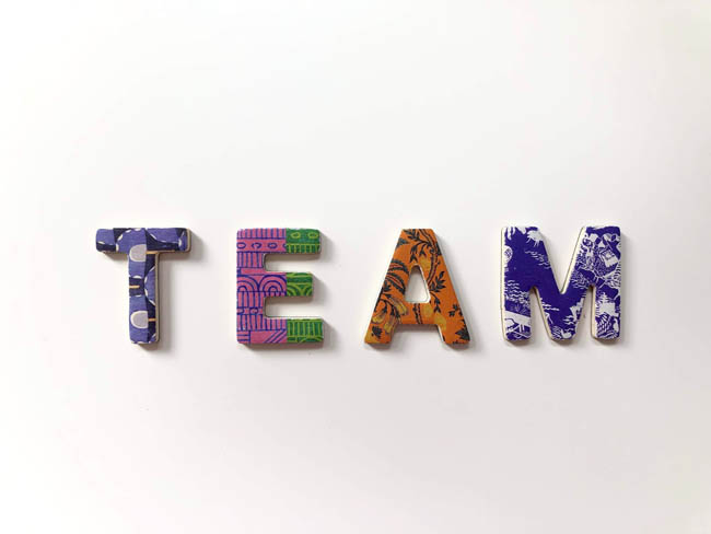 team in different colored letters