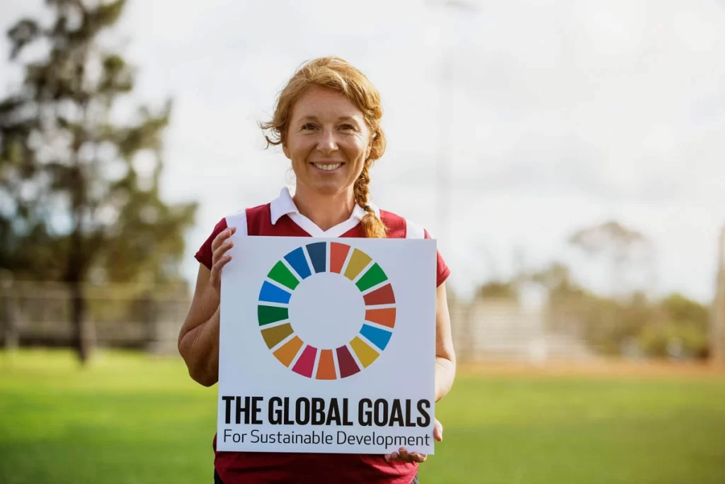 brandi holding global goals sign