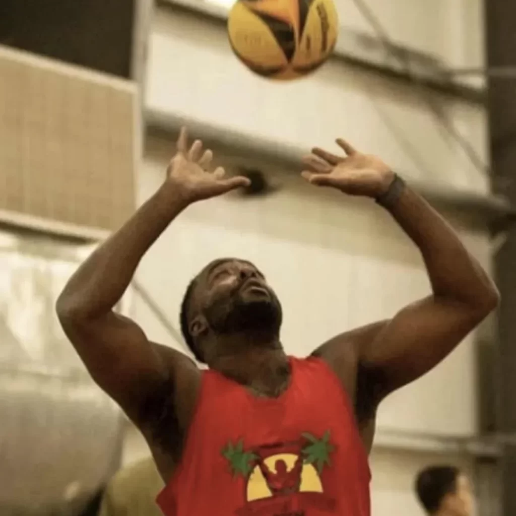 Ray Bell, Gametime Hero sports app developer in red shirt shooting basketball